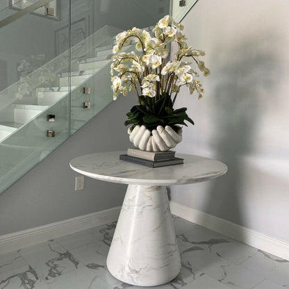 White Phalaenopsis orchids in a vase, open hand sculpture